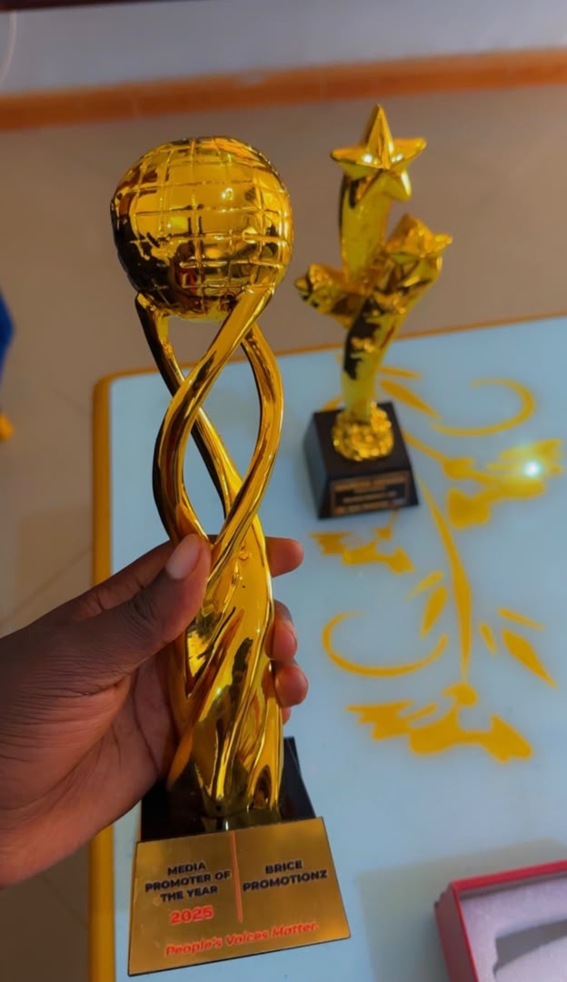 Brian Ayesiga shows off an accolade he recently won. Courtesy Photo