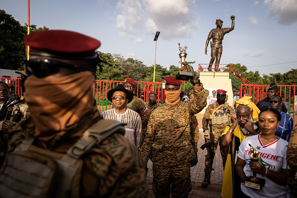 Captain Ibrahim Traore, Burkina Faso's new president, poses with the torch given by elders revolutionary during the ceremony for the 35th anniversary of Thomas Sankara&rsquo;s assassination, in Ouagadougou, on October 15, 2022. Captain Ibrahim Traore, who took power a fortnight ago in a coup in Burkina Faso, attended a ceremony on October 15, 2022 to mark the 35th anniversary of the assassination of revolutionary president Thomas Sankara, an AFP reporter noted. 