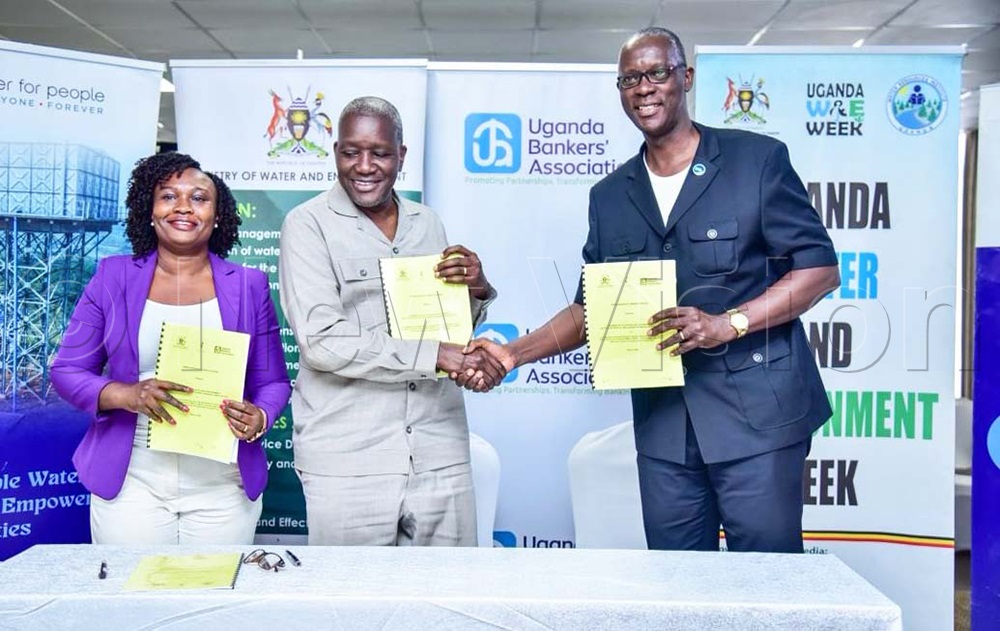 Brenda Achiro (left), Water for People country director, Dr Alfred Okidi, water ministry PS and Wilbrod Humphreys Owor, Uganda Bankers Association ED, display copies of signed MOUs during the breakfast meeting at Skyz hotel in Naguru on Friday, March 6, 2026. (Photo by Juliet Kasirye)