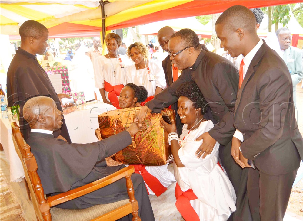 Catholic Catechists gifting Fr. Dr. James Kabuye during his priestly diamond jubilee function at Kiyinda-Mityana catechetical Centre in December 2022.