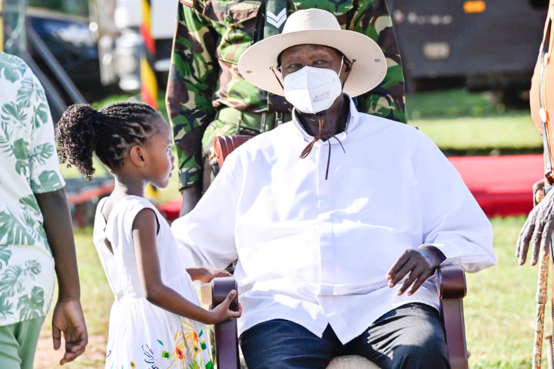President Yoweri Museveni interacting with a young child at the event...