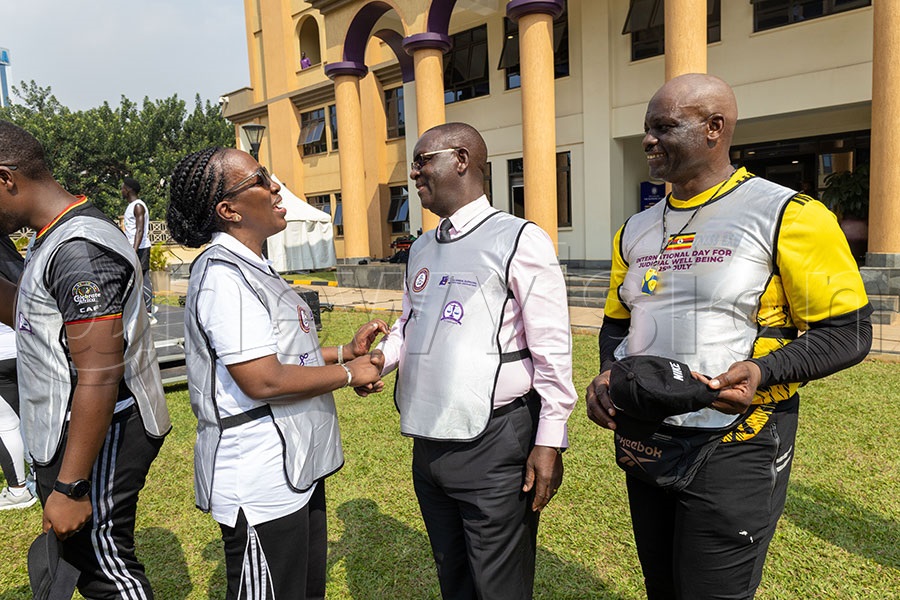 Lady Justice Olive Kazaarwe Mukwaya chats with the Permanent Secretary (PS) and secretary to the judiciary, Dr. Pius Bigirimana, as coach Robert Ssebugwawo looks on after demonstrating a workout routine to judicial fficers at the inaugural International Day for Judicial Well-being. Photo by Richard Sanya 