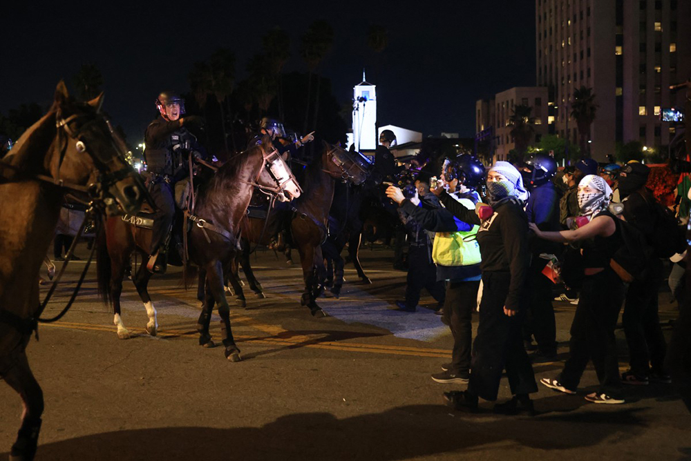 Mounted LAPD officers push back a crowd of protesters that gathered at the Metropolitan Detention Center after a rally during the "No Kings" national day of protest in Los Angeles, California on October 18, 2025. From New York to San Francisco, millions of Americans are expected to hit the streets to voice their anger over President Donald Trump's policies at nationwide "No Kings" protests.
