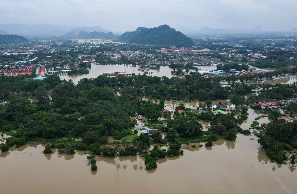 An aerial view shows residential areas surrounded by flood waters in Kangar in northern Malaysia's Perlis state on November 27, 2025, as severe flooding affected thousands of people in the region following days of heavy rain.
