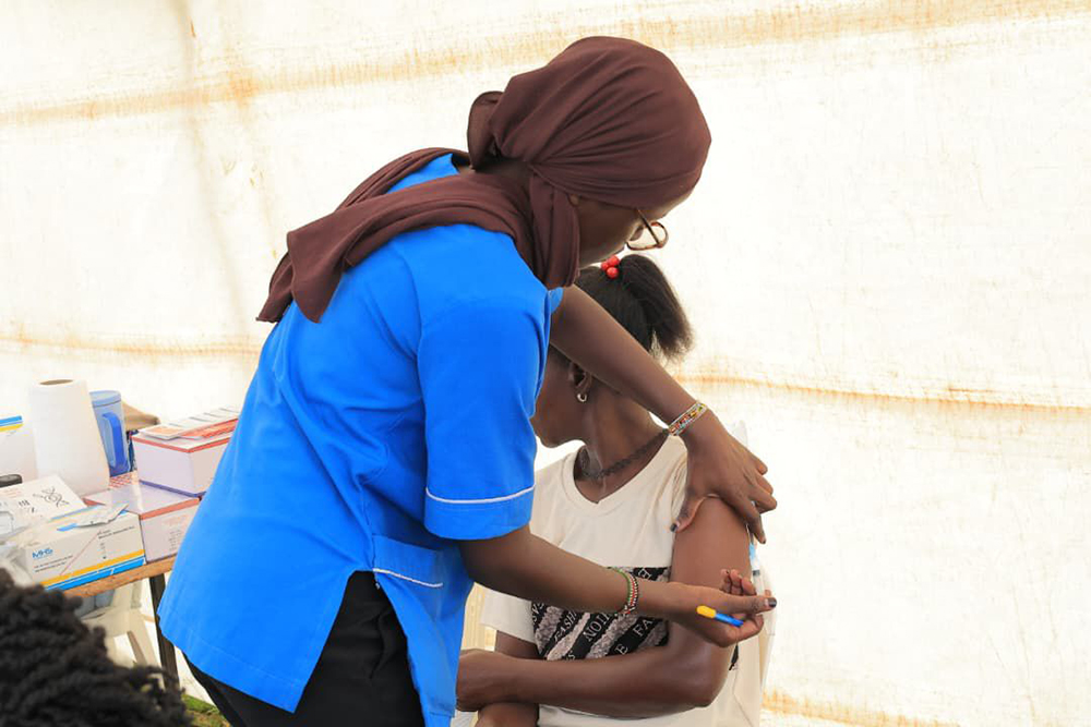 A resident of Kasenyi Landing Site receiving much-needed medical attention. (Courtesy)