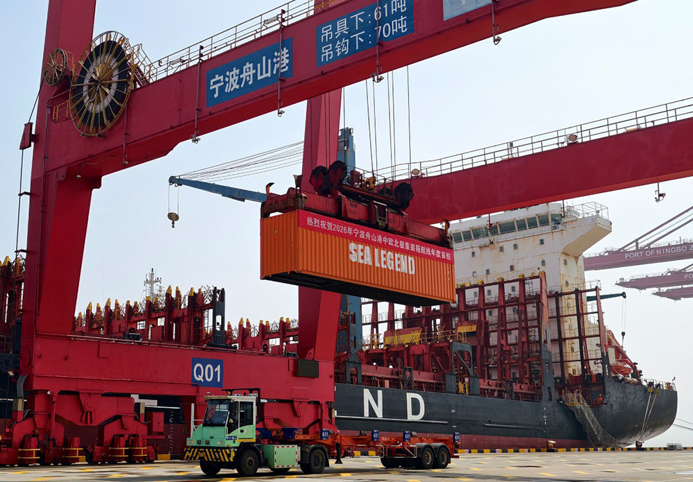 A banner reading "Warmly Congratulate the first annual voyage of the China-Europe Arctic Container Route at Ningbo-Zhoushan Port in 2026", is displayed on a container at the Ningbo-Zhoushan port in Ningbo, eastern China's Zhejiang province on August 15, 2026. (Photo by CN-STR / AFP)