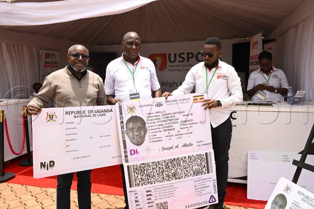 The Uganda Printing Security Company share gifts with Vision Group CEO, Don Wanyama
