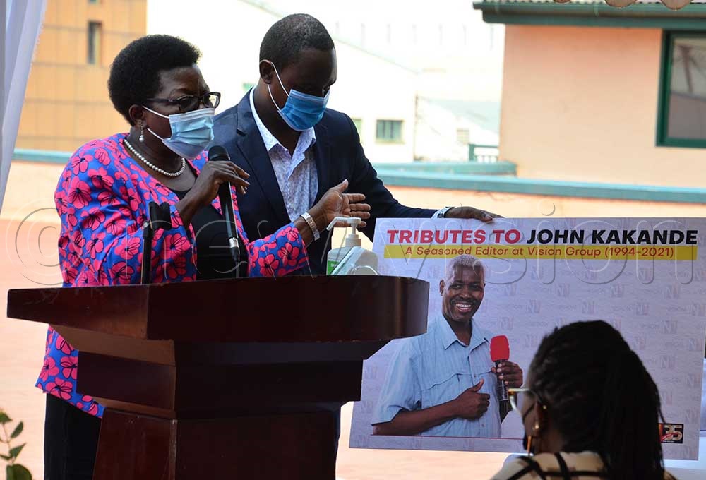 New Visionâs Senior producer Hellen Mukiibi addresses Vision Group staff during Kakande sendoff party as Frank Kabushenga, the company Administration Manager looks on.