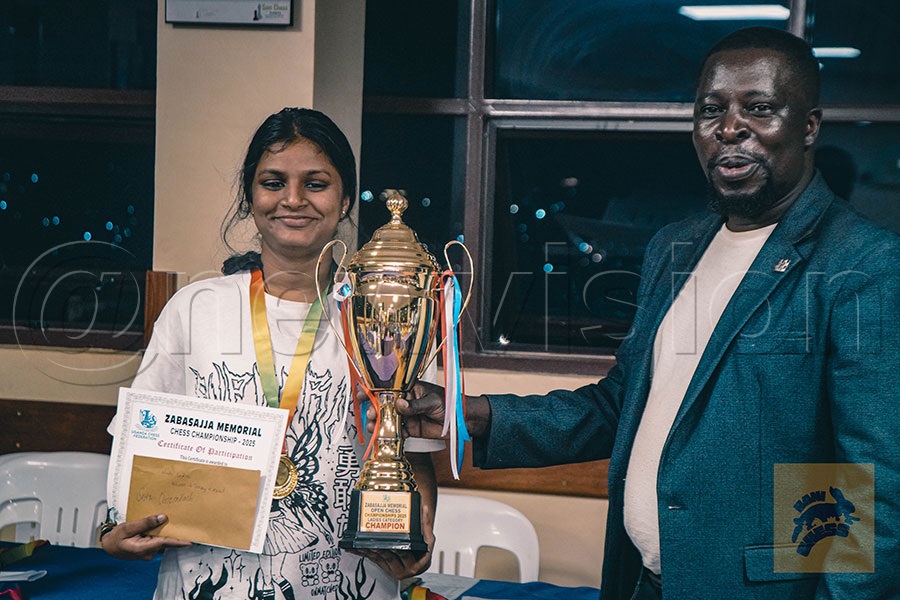 Mwaka hands over a trophy recently