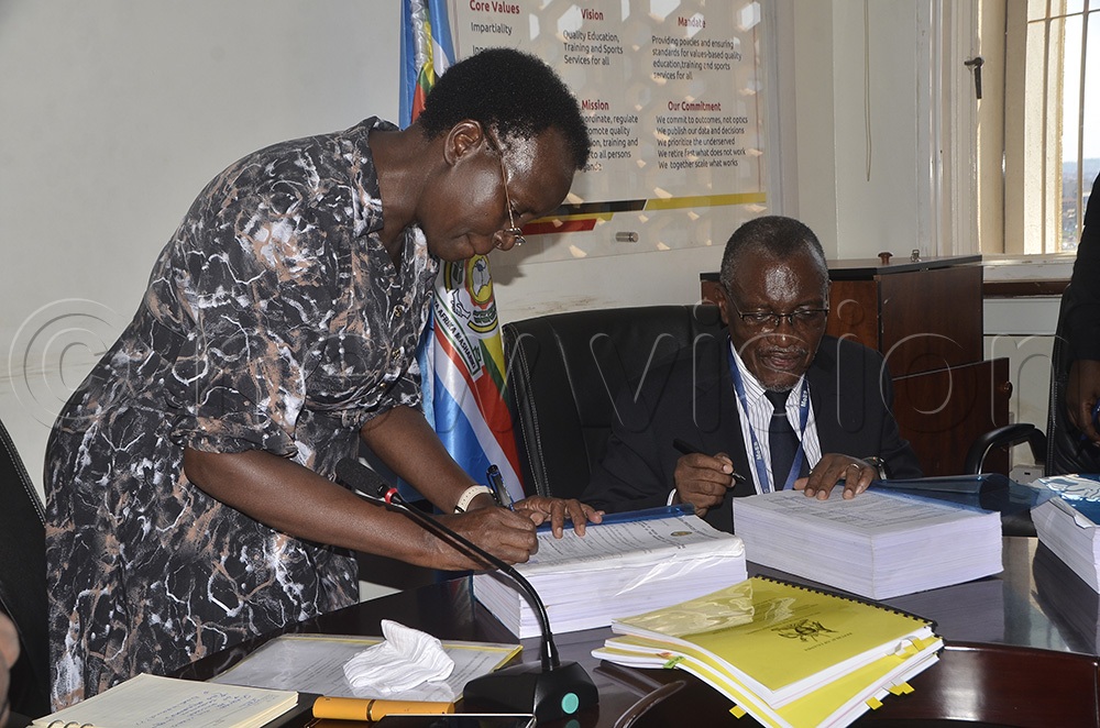 Permanent Secretary, Ministry of Education and Sports, Dr. Kedrance Turyagyenda and Prof. Samuel Kyamanya, Bunyoro University taskforce chairperson, sign a memorandum of understanding (MOU) with the UPDF brigade for the construction of Bunyoro University. (Photo by Nicholas Kajoba)