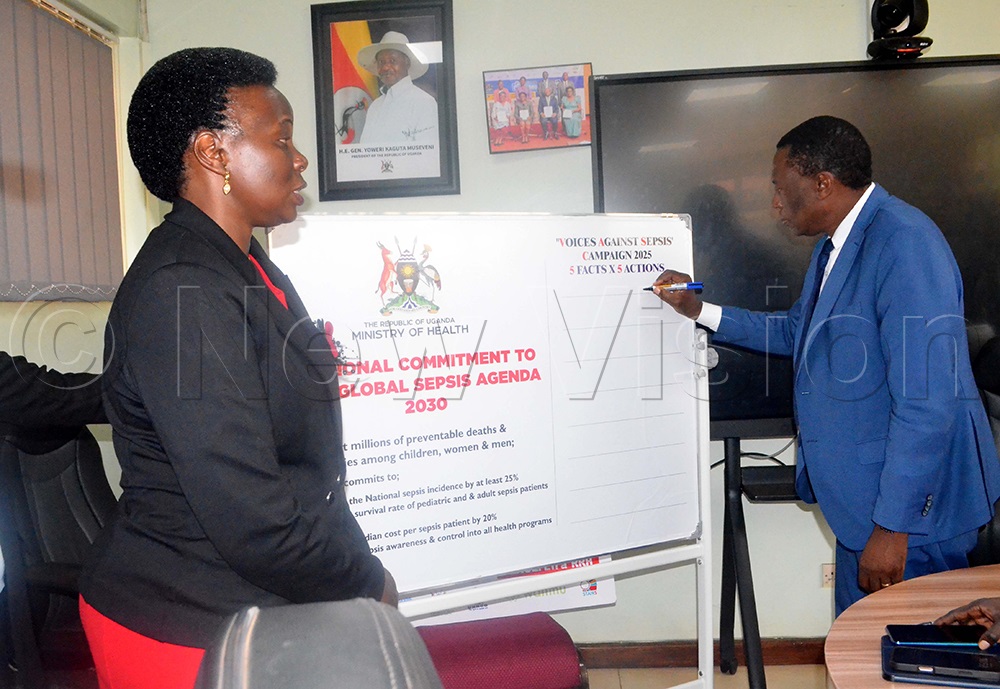 Dr Charles Olaro, Director General Health Services at the Ministry of Health, signing during the commemoration of Sepsis Awareness month under the Voices Against Sepsis, at the Ministry of Health, as Dr Susan Nabadda, Commissioner in charge of National Health Laboratory Services, looks on. (Photo by Violet Nabatanzi)