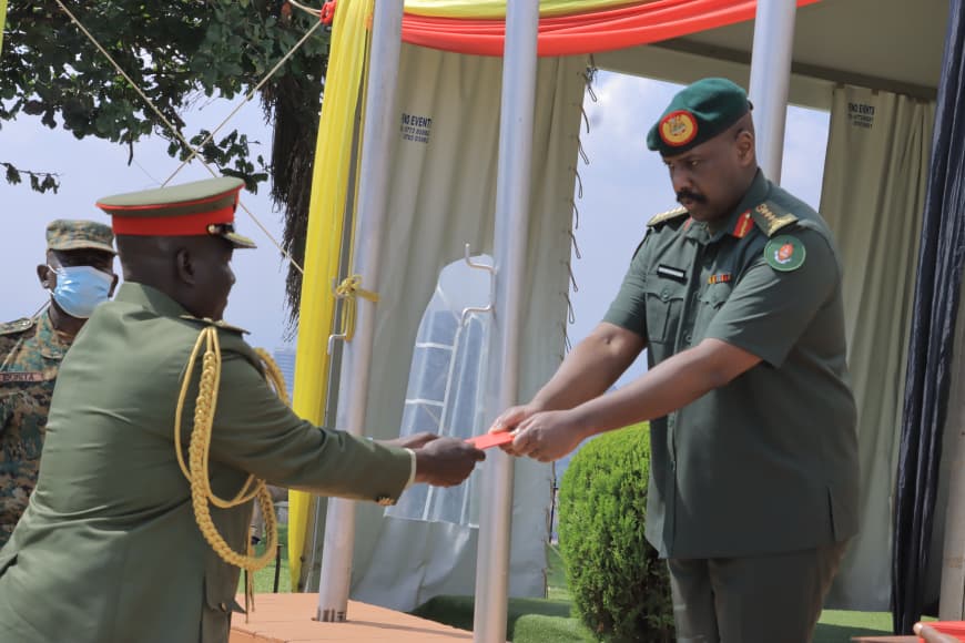 CDF Gen. Muhoozi Kainerugaba awards a discharge certificate to one of the retiring senior officers during the retirement ceremony at the UPDF Joint Services Headquarters in Mbuya on August 12, 2026. (Courtesy)