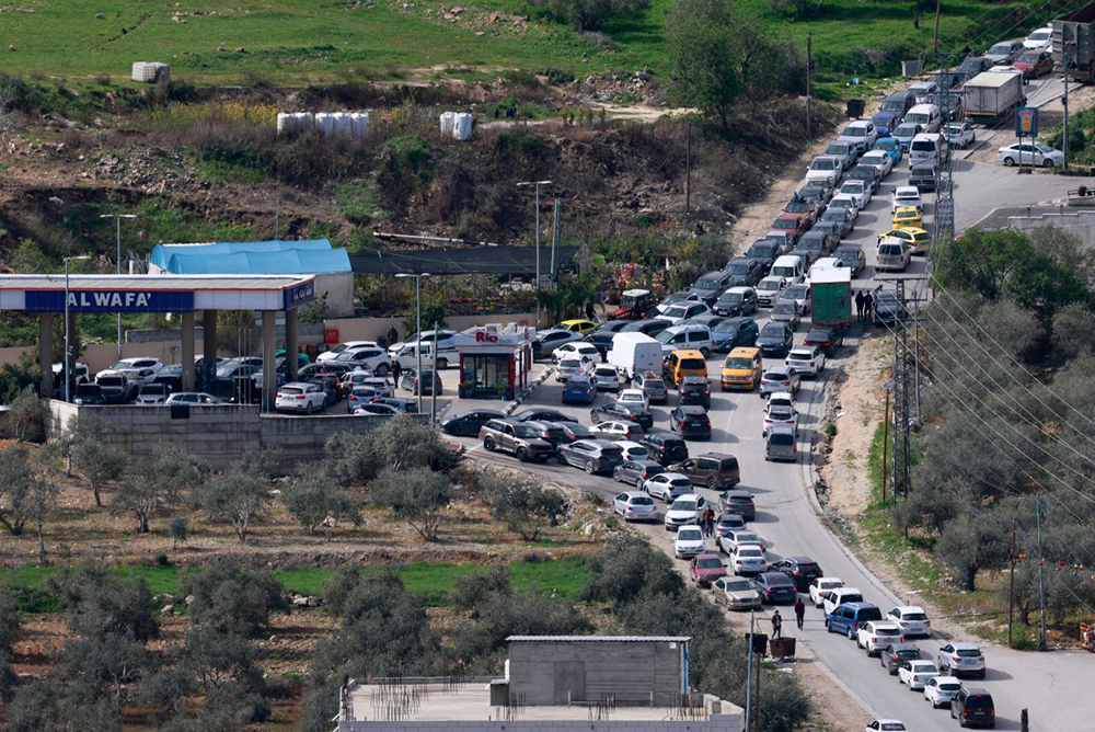 People rush to fill their tanks at a petrol station in Nablus, in the occupied West Bank on February 28, 2026, after Israel and the US launched attacks on Iran. (Credit: AFP)