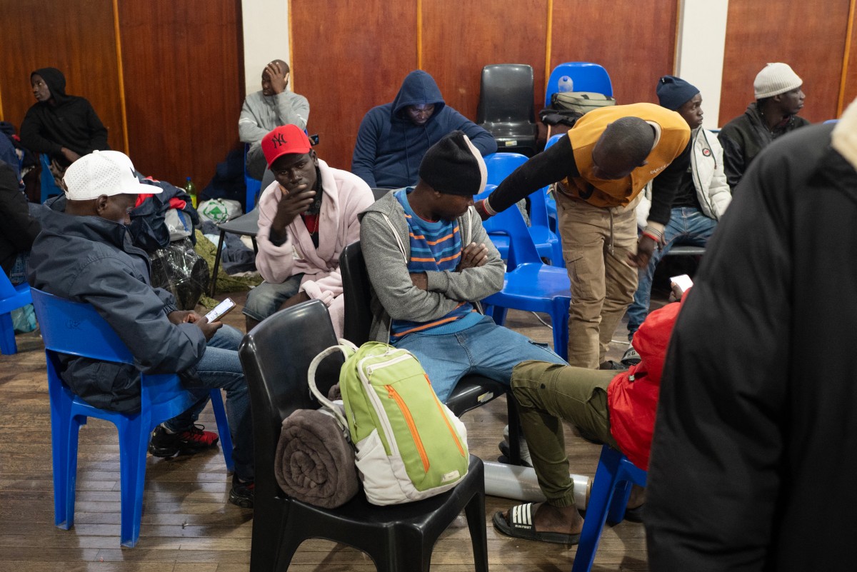 Immigrants, mostly from Malawi, take refuge in a community hall in Kleinmond, some 100km from Cape Town, on June 2, 2026, after they were threatened in the communities in which they live. (Credit: AFP)