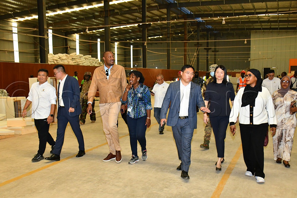 The State Minister for Privatisation and Investment, Hajjati Aminah Mukalazi (right) and UIA's Director General Robert Mukiza (3rd left) being led by the Tian Tang Group Managing Director Luke Wang (3rd left) in touring one of the factories in Sino -Uganda Mbale Industrial Park. (Photo by Donald Kiirya)
