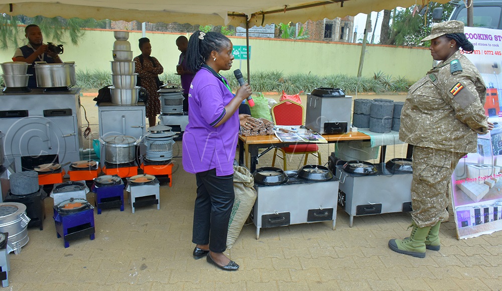 Vanice Mirembe (right), the UWA Manager in charge of conservation education and awareness, inspecting some of the stalls displaying cooking stoves that use solar. (Photo by Julius Luwemba)