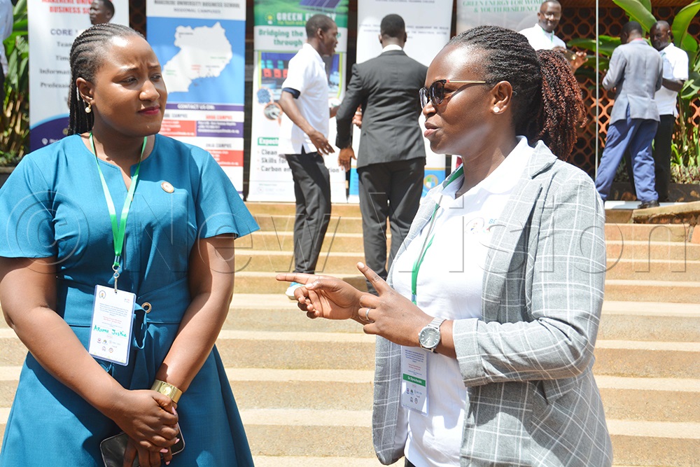Dr Sylvia Aarakit (right), the project principal investigator at Makerere University Business School, interacts with Justine Akumu, the senior clean cooking officer at the Energy Ministry, after the opening of the green energy for women and youth workshop at Nakawa Vocational Training College in Kampala on March 30, 2026. (Photo by Francis Emorut)