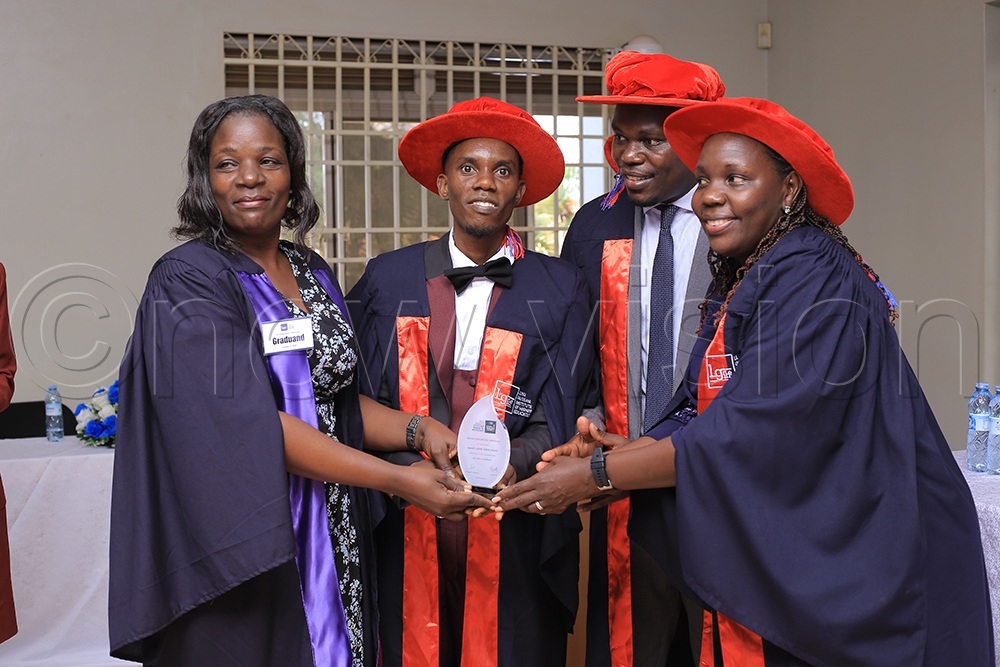 Stella Rose Akongo, Principal of Luigi Giussani Institute of Higher Education (right), and other officials award a top-performing student during the institute’s graduation ceremony. (Credit: Derrick Muduku)