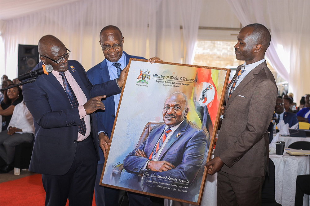 Incoming works and transport minister Fred Byamukama giving the outgoing minister Gen. Edward Katumba Wamala a token of appreciation during the handover. (Credit: Ministry of Works)