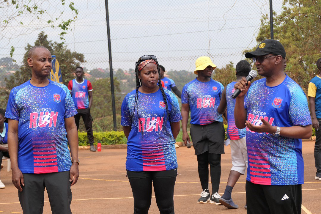 George M. Kitaakule (District Rotary Governor 9213) (right), delivers his speech during the UCU Tuition Run 2025, as Vice Chancellor Canon Assoc. Prof. Aaron Mushengyezi (left) and Director of Academic Affairs Assoc. Prof. Angella Napakol (centre) look on. (Credit: UCU)