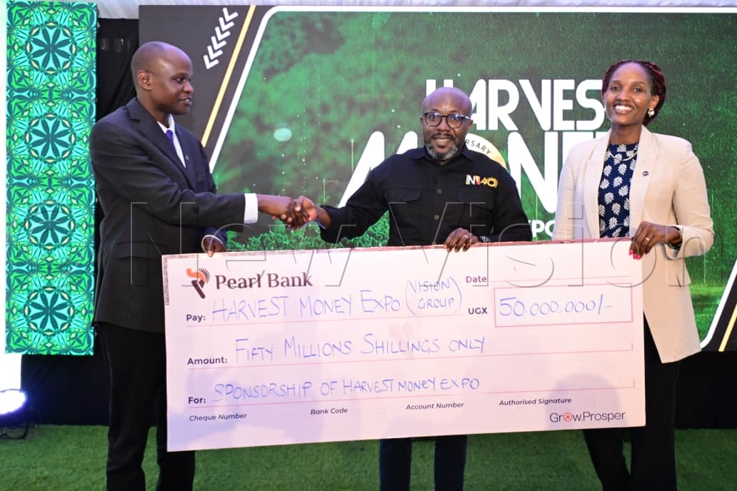 Vision Group CEO, Don Wanyama, receiving a cheque from Pearl Bank.