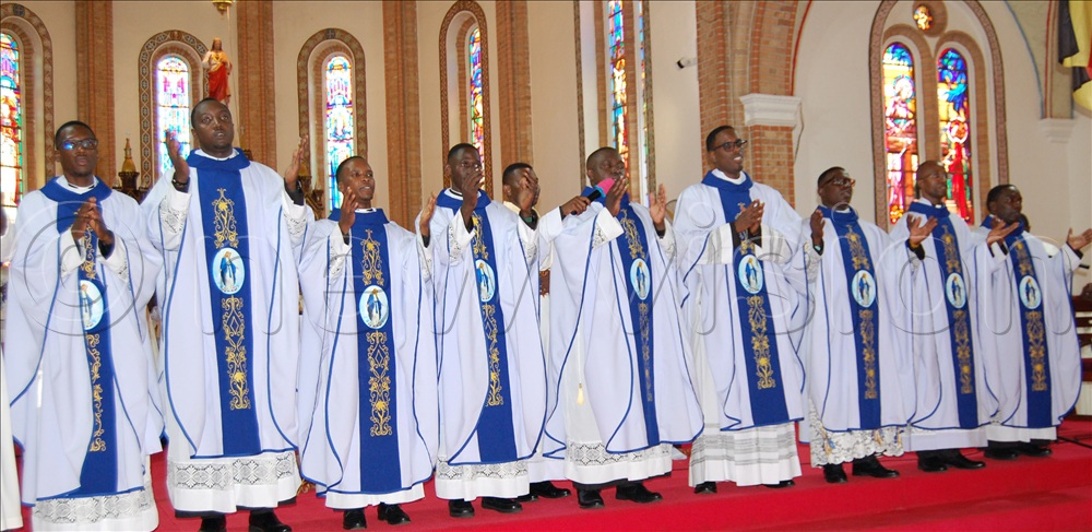 The newly-ordained priests imparting a sacerdotal blessing to the congregation.
