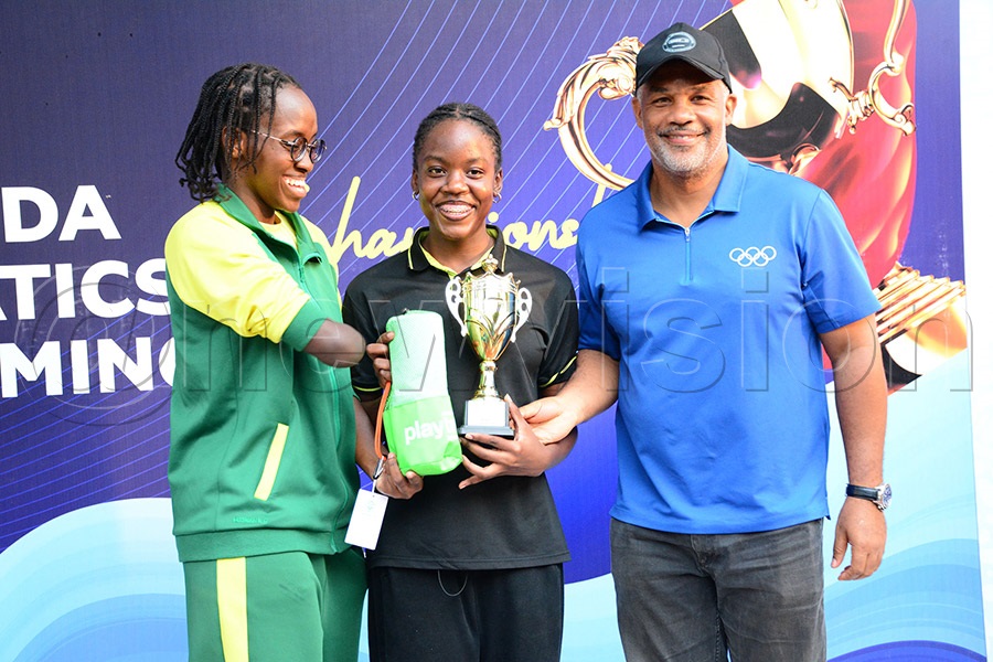 IOC member William Blick (right)  and Husnah Kukundakwe (left) present prizes to the best girl in the 13-14 Women category after the Uganda Aquatics nationals at KISU, July 5, 2026. Photo by Michael Nsubuga