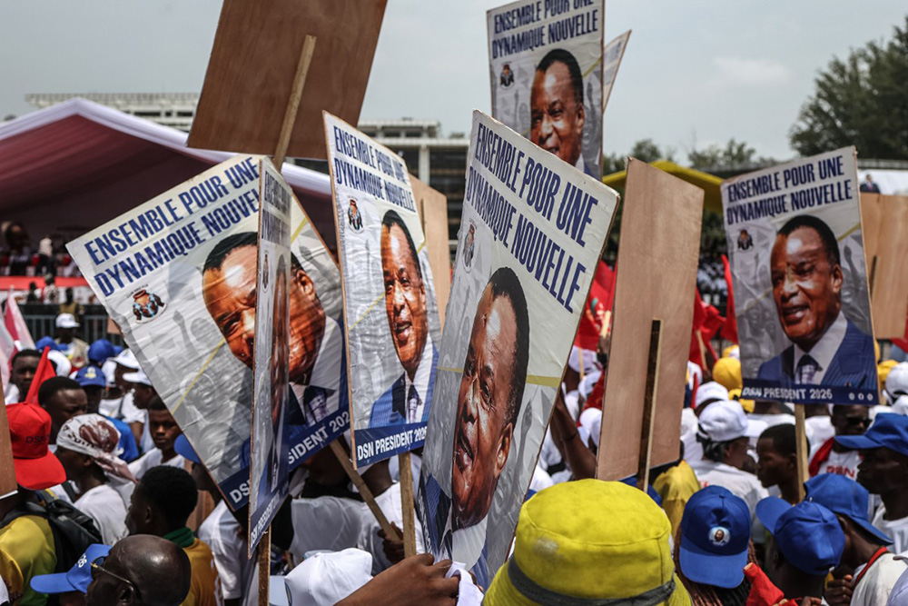 Supporters hold posters of incumbent President of the Republic of Congo and presidential candidate Denis Sassou Nguesso, as they attend a campaign rally in Brazzaville on March 13, 2026 ahead of Congo's presidential election scheduled for March 15, 2026. (Photo by Daniel BELOUMOU OLOMO / AFP)