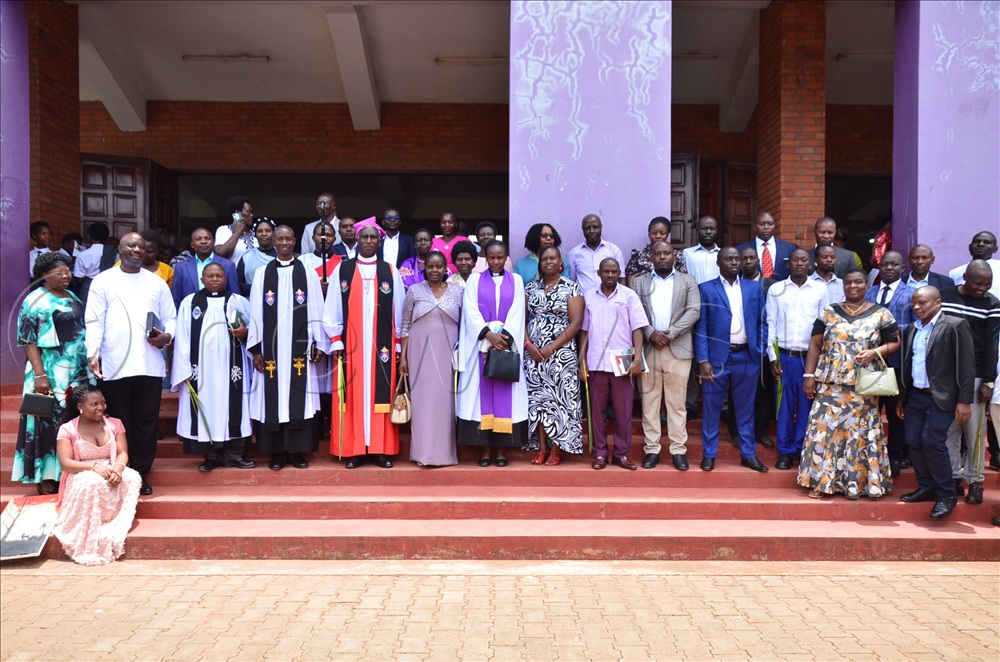  Bishop Kisembo and staff of Kyebambe Girls pose for a photo after the prayers.