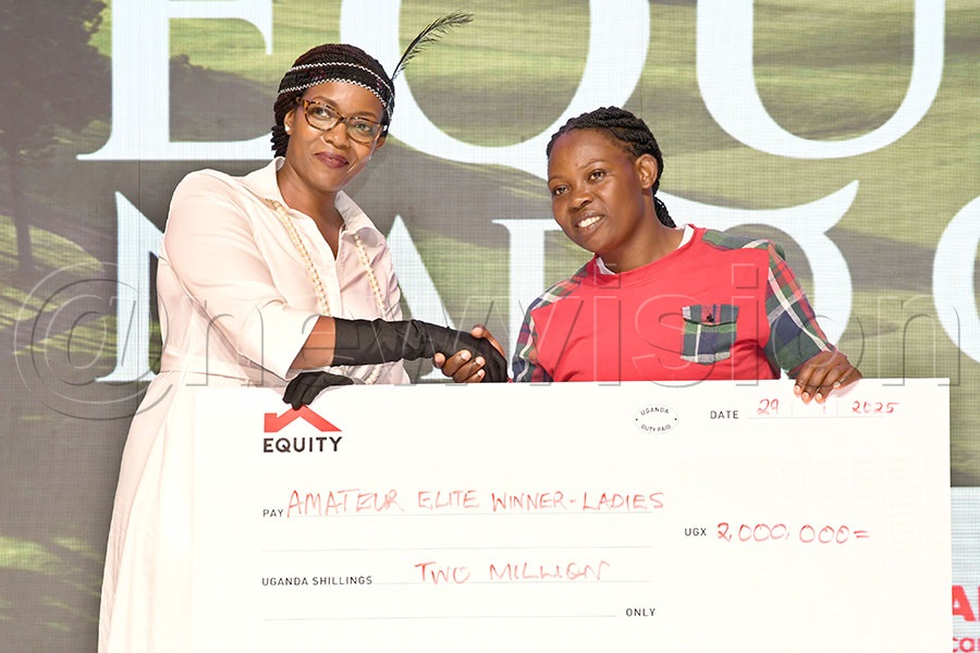 Equity Bank’s head of marketing and communication Clare Tumwesigye (left) presents a sh2m cheque to the ladies overall winner Meron Kyomugisha after the Equity-NARO Golf Open in Namulonge. Photo by Michael Nsubuga