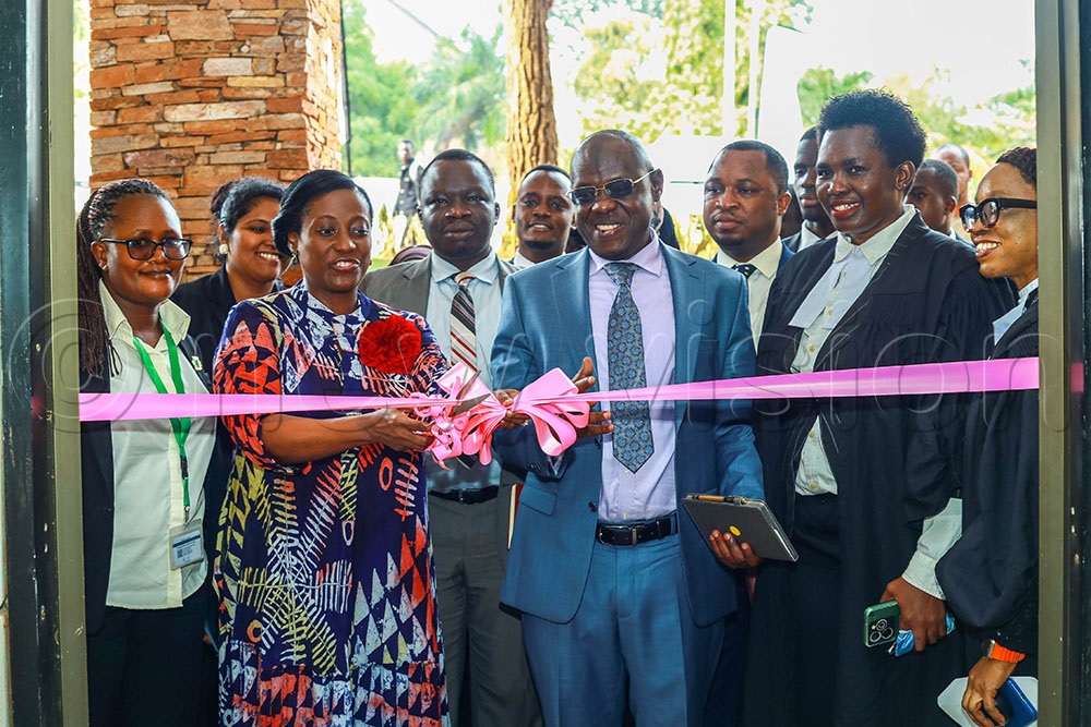 Justice Monica Kalyegira Mugenyi cuts a ribbon as she launched the Moot court at Kampala International University (KIU), alongside the university vice chancellor Prof Ngoma Muhammed, among other officials, on Friday. (Credit: Agnes Kyotalengerire)