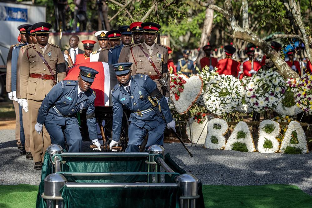 Senior military officials serving as pallbearers carry the coffin of Kenya’s opposition leader and former Prime Minister Raila Odinga past floral wreaths reading “Baba”, meaning “father” in Swahili and Odinga’s popular nickname, during his burial ceremony in Bondo, on October 19, 2025. 
