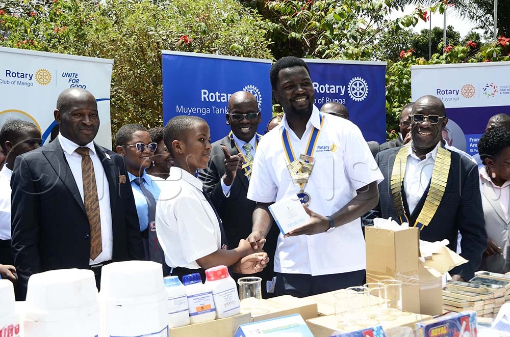 Kenneth Rubango (second right), Rotary Club of Muyenga Tank hill president hands over science lab equipment to students during the launch Science Education Uplift Uganda Rotary Initiative at Mackay Memorial College in Nateete in Wakiso district on 17th September 2025. Looking on from left is Francisco Ssemwanga, district Governor of D9214. (Credit: Juliet Kasirye)