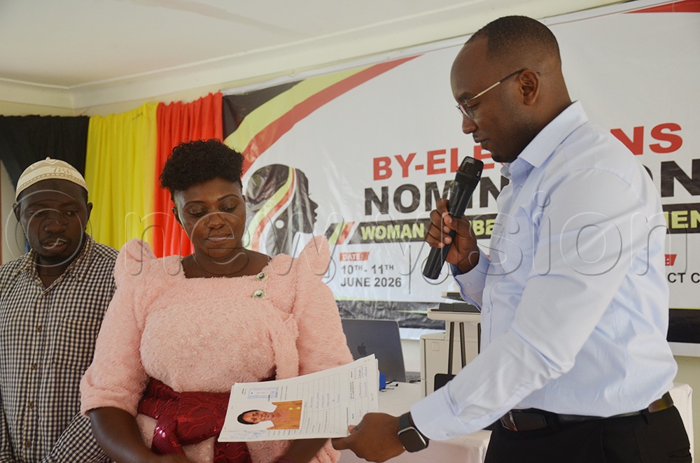 Ronald Agaba handing over declaration papers to one of nominated candidate Agnes Nassuuna to contest on Woman MP seat for Kalangala district. (Credit: Samuel Nkuba)