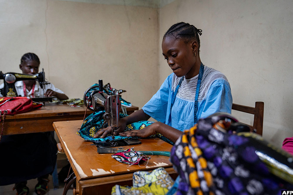 A girl who has been taken off the streets learns cutting and sewing at the training centre of the NGO OSEPER in Kinshasa