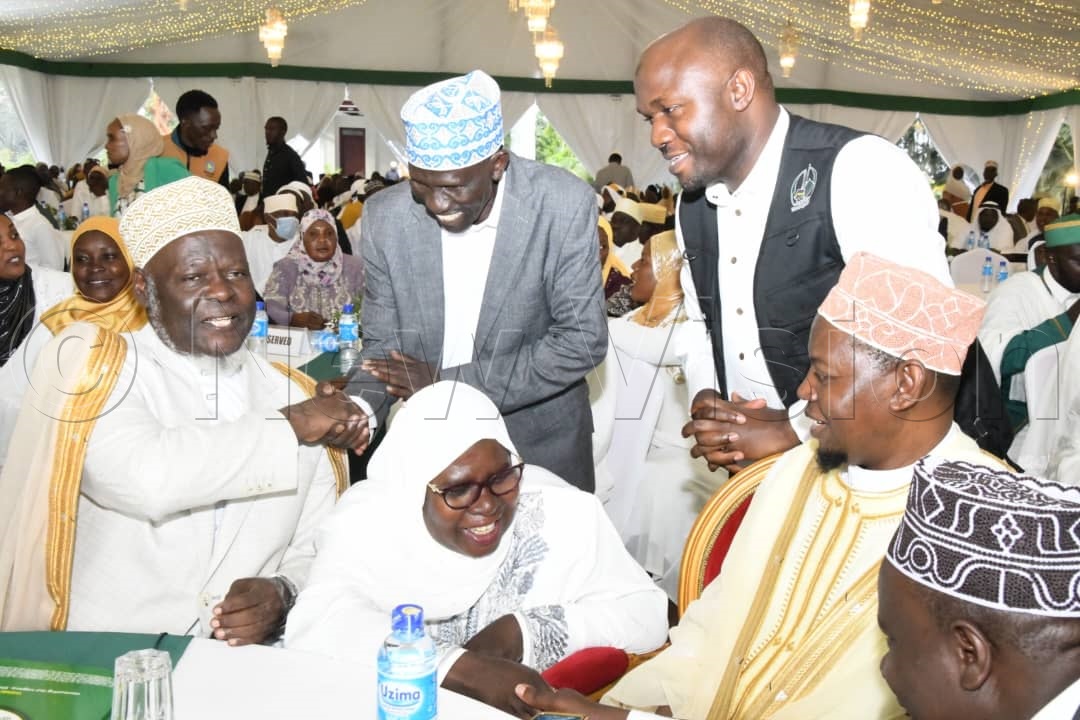Sheikh Shaban Mubaje (Left), Grand Mufti of Uganda, being greeted by other guests at the event.