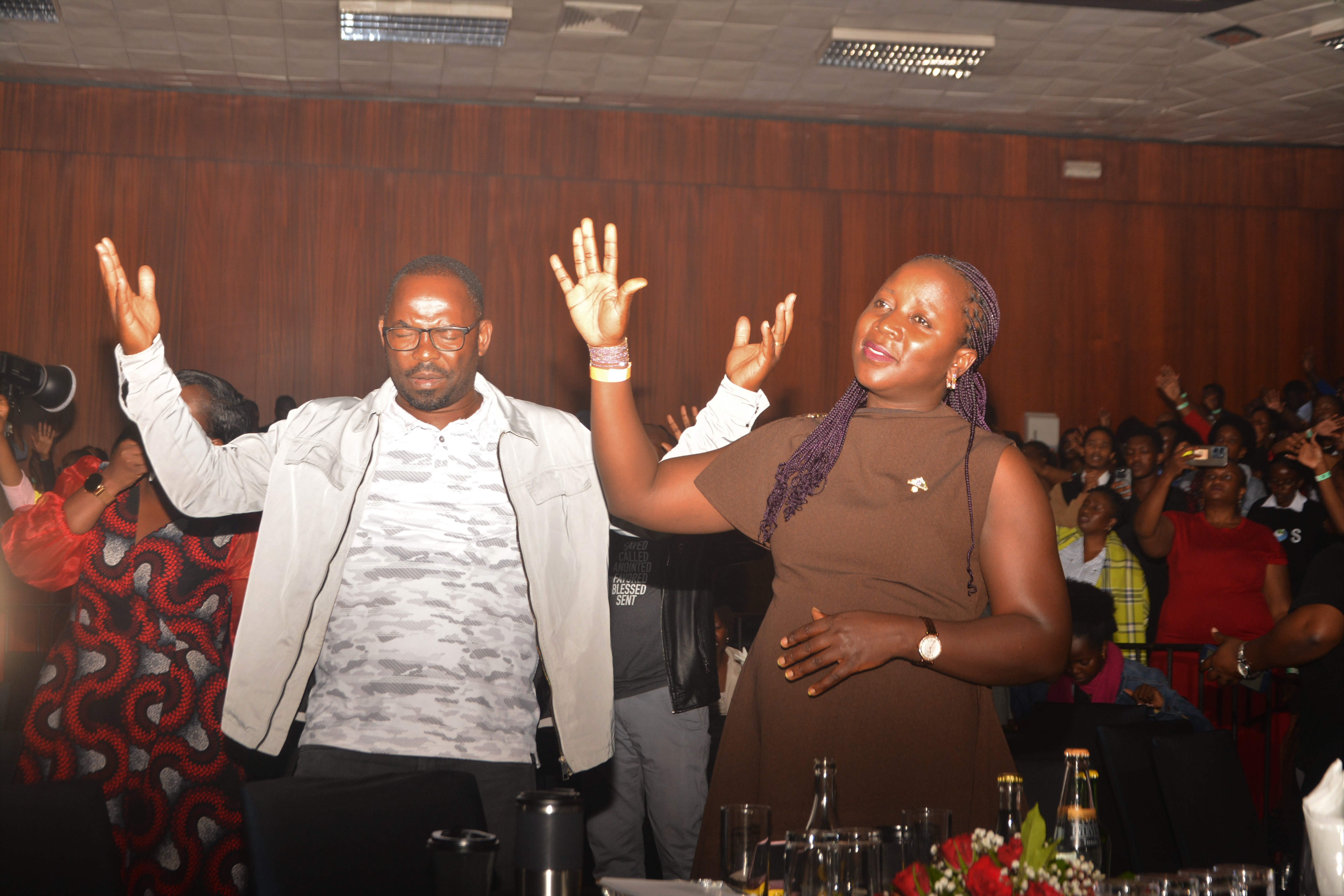A Couple Worshipping With Pr. Isaac Serukenya Photo By Alfred Byenkya