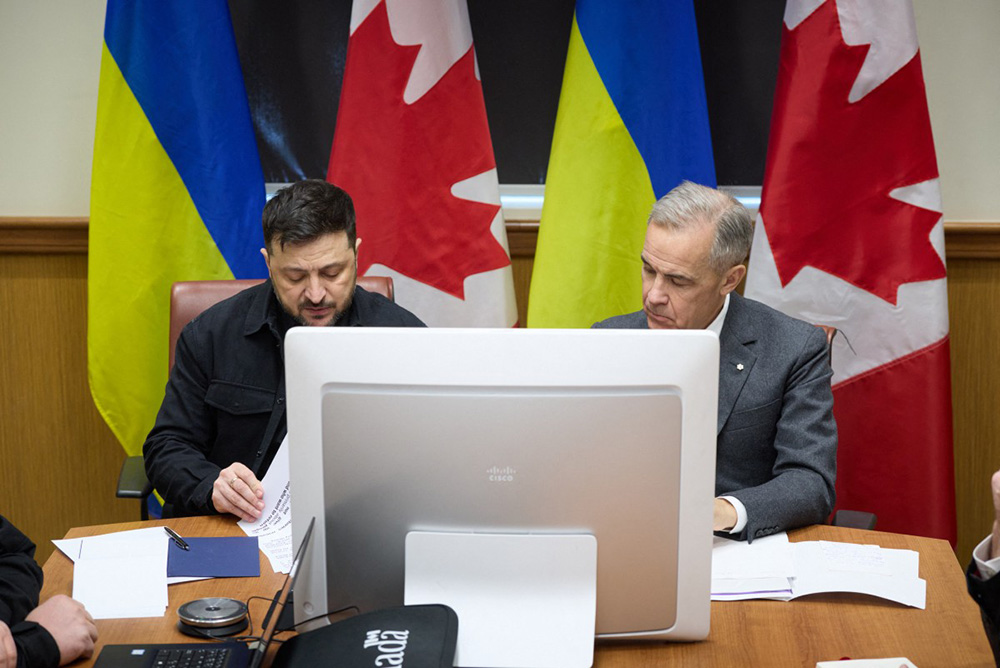 Ukraine's President Volodymyr Zelensky (L) and Canadian Prime Minister Mark Carney during their meeting in Halifax, Nova Scotia, Canada. (Photo by HANDOUT / UKRAINIAN PRESIDENTIAL OFFICE / AFP)