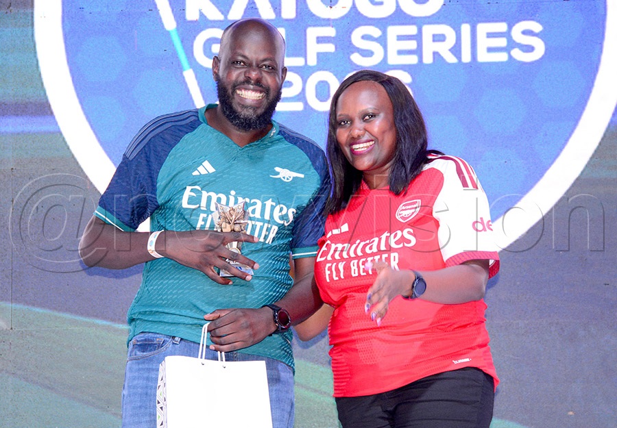 Ivan Arinaitwe (left) receives his Group A prizes from UBL's Finance & Strategy Director Josephine Njoroge after the Katogo second quarter tournament at Entebbe Club, May 30, 2026. Photo by Michael Nsubuga