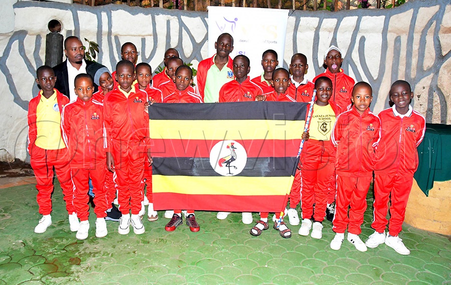 Scrabble players pose for a group photo with NCS official Ivan Niwamanya (back right) after being flagged off for the World Youth Championships in Kenya. Photo: Silvano Kibuuka