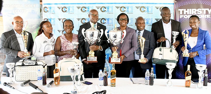 UCAA Acting Director General Olive Lumonya (4th right) alongside  her staff members, USGA's David Baraka (4th left) and Ruth Ssali (3rd left), UCAA Crown Beverages' Brand & Communications Manager Sandra Againe (2nd left) pose with some of the prizes during the launch of the UCAA Seniors Golf Open Championship at Kitante. Photo by Michael Nsubuga