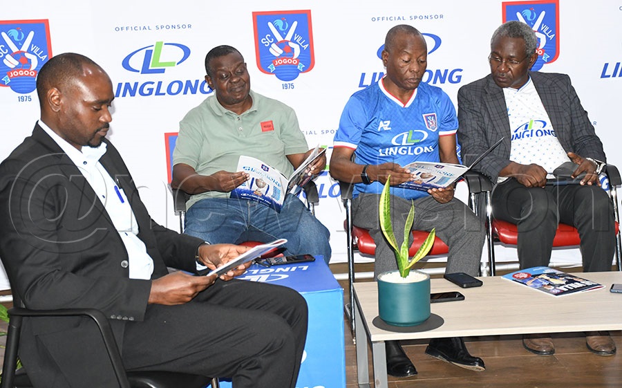 SC Villa assistant CEO Sulaiman Mutajazi (left), executive member Salim Ssemmanda (2nd left), Villa Spokesperson Asan Kasingye (3rd left), and CEO William Nkemba read through copies of the magazine at a press conference held at Mandela Auto Zone in Industrial Area. Photo by Michael Nsubuga