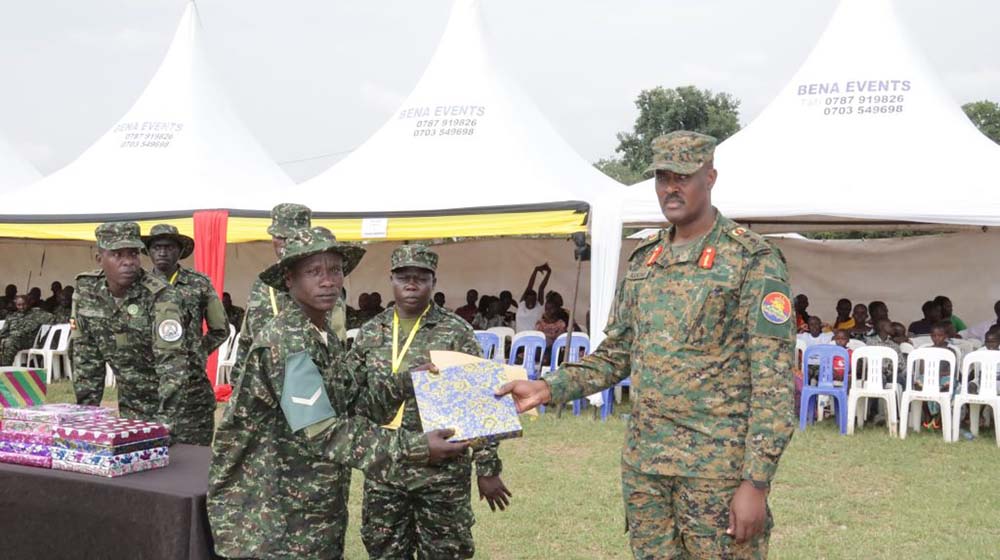 Maj Gen Dan Kakono, Commander Artillery Division, awards one of the best performers. (UPDF Photo)
