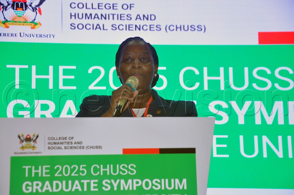 Prof. Hellen Nkabala, the principal of the College of Humanities and Social Sciences (CHUSS) addressing delegates and participants at the official opening of the 2025 College of Humanities and Social Sciences (CHUSS) Graduate Symposium at the Makerere University Main Hall. (Credit: John Odyek)