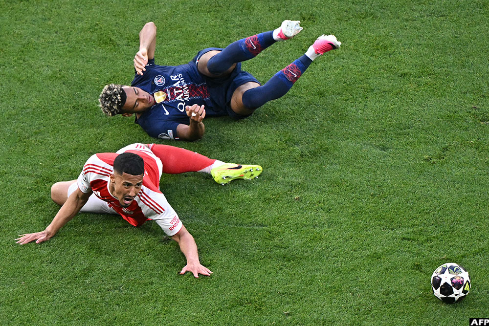 Arsenal's defender William Saliba and PSG's midfielder Desire Doue faced off