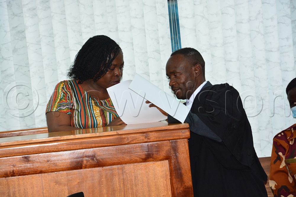 Nandutu interacting with her lawyer during a court session today. (Credit: Alfred Ochwo)