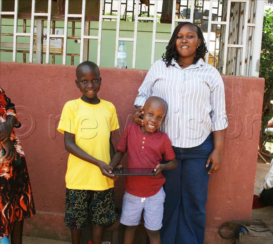 Zain Lule who is battling Luekemia with his mom and a friend at Mulago.