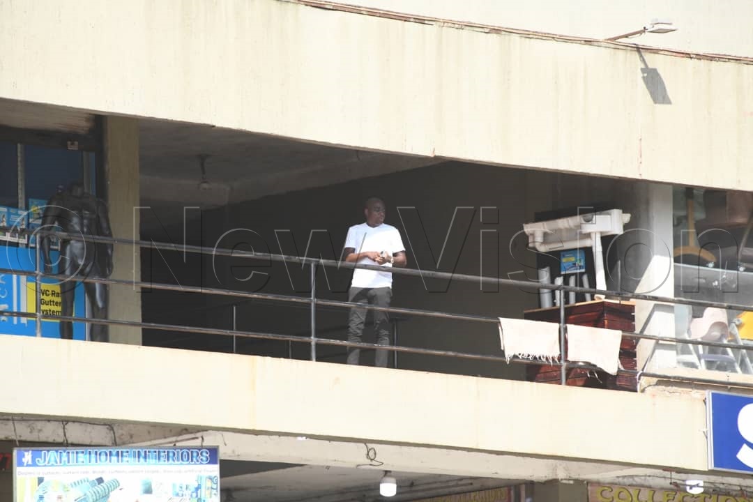 Ham monitoring the situation from above a balcony. (Credit: Mpalanyi Ssentongo)