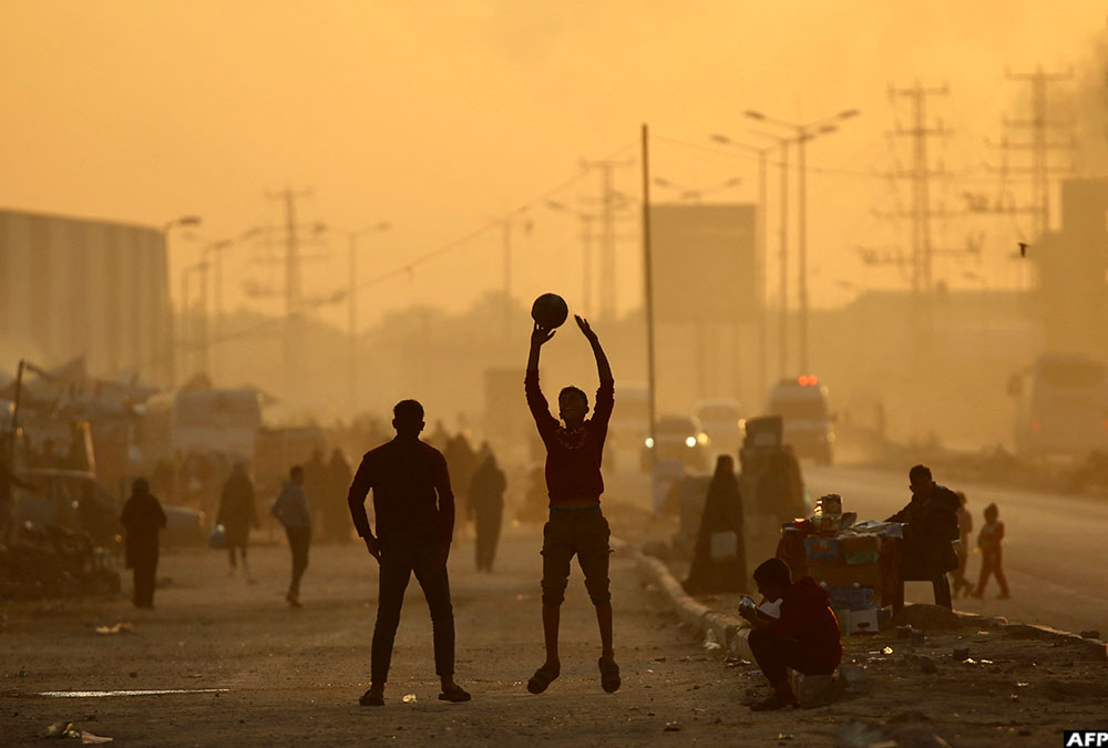 Children play at the Nuseirat camp for displaced Palestinians in the central Gaza Strip on December 22, 2025.
