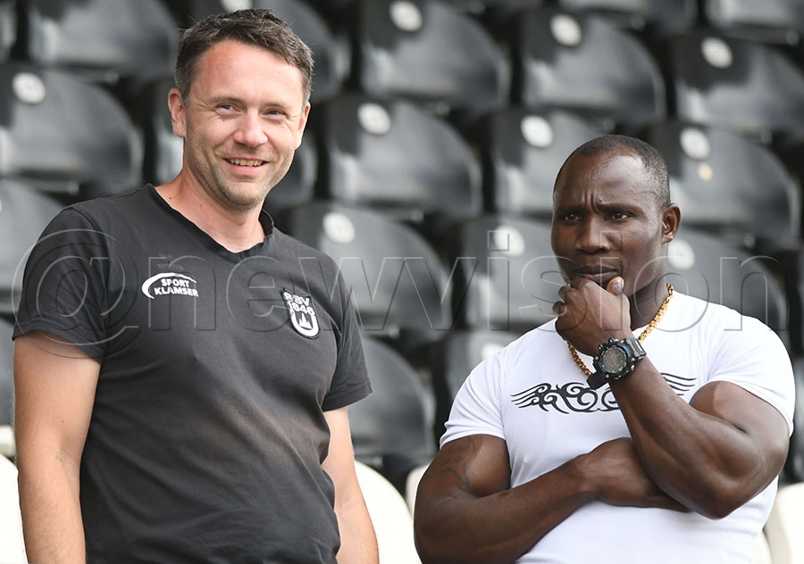 Veit Rauscher (left) the head coach at the SSV Ulm 1846 Club shares a moment with Ivan Byekwaso at the Ulm Stadium. Photo by Michael Nsubuga